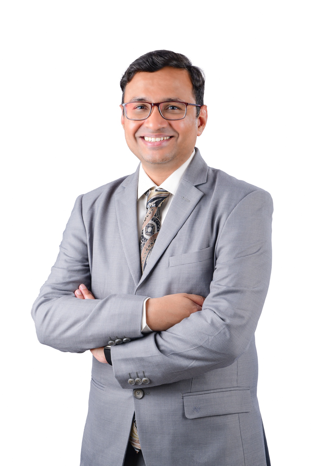 Dr. Sachin Arakere Nataraj smiling in a grey suit